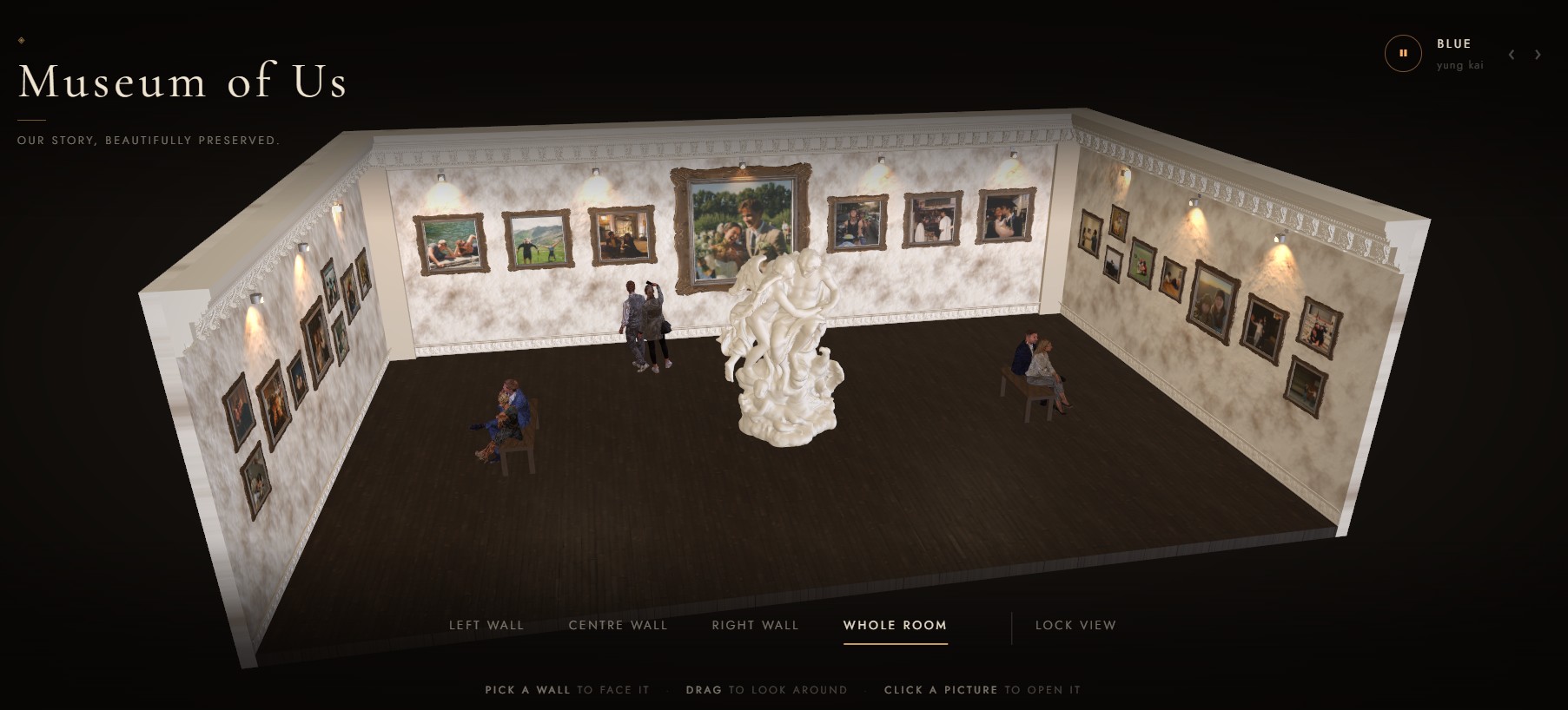 The whole gallery seen from above: three walls of framed photographs, a marble sculpture at the centre and visitors on benches